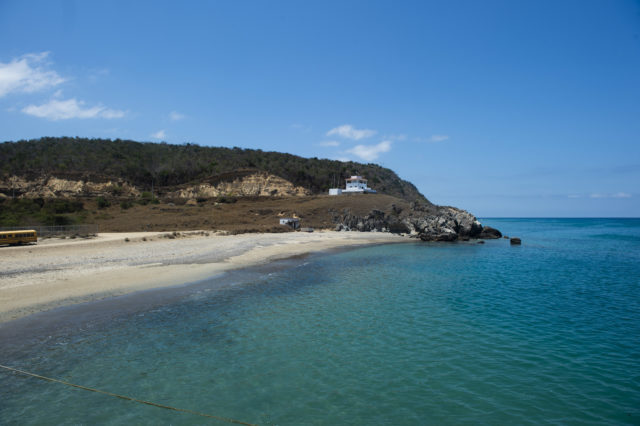 A coastline view with a hill in the background