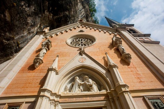 View looking up at the front face of the Santuario Madonna della Corona.