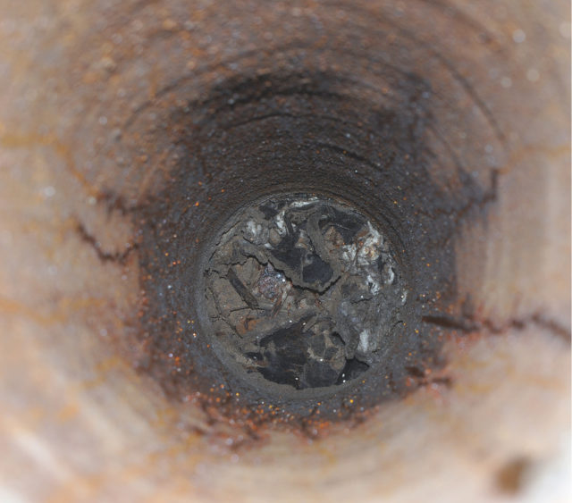 View of the inside of a rusted ventilation pipe