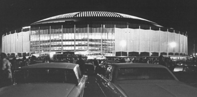 Cars parked in the lot outside of the Houston Astrodome