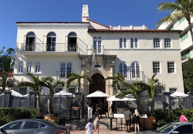 Front exterior of the Villa Casa Casuarina with umbrellas on a patio.