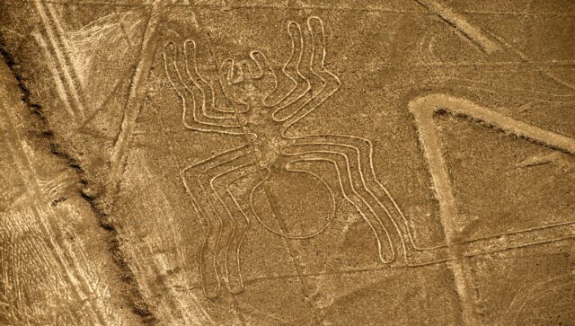 An aerial view of what appears to be a spider etched into the ground at the Nazca archaeological site.