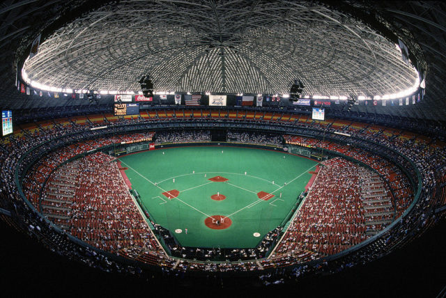 Crowd gathered around the baseball pitch at the Houston Astrodome