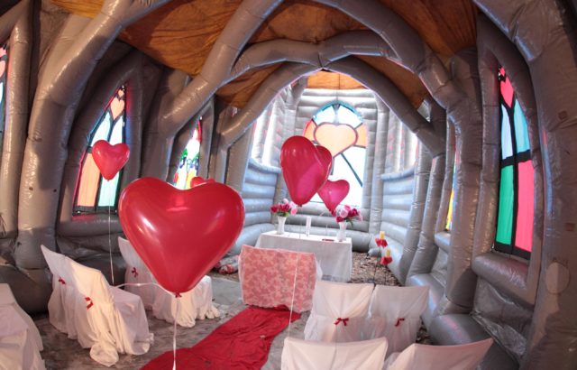 Heart balloons between the pews of the Inflatable Church