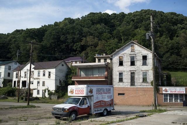 A truck in front of old abandoned homes in Cleveland