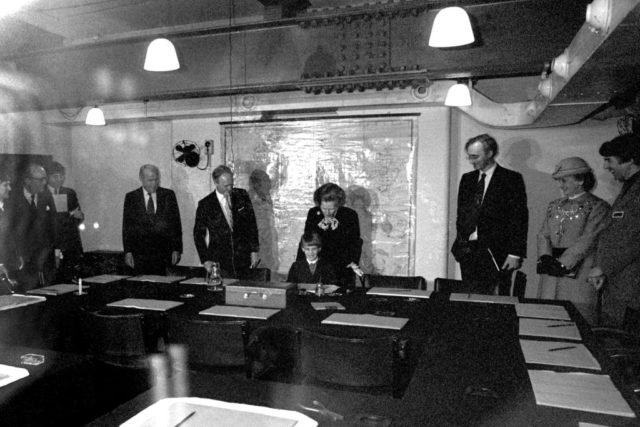 Margaret Thatcher and a group of government officials gathered around a large table