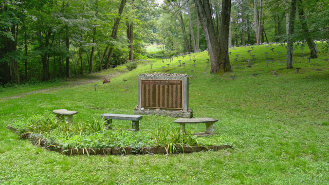 Benches in front of a memorial at a cemetery
