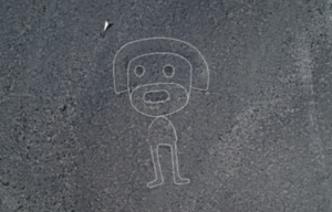 An aerial view of what appears to be a humanoid figure etched into the ground at the Nazca archaeological site in Peru