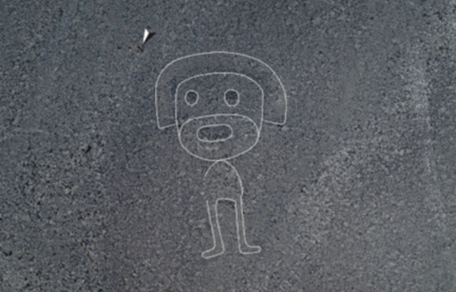 An aerial view of what appears to be a humanoid figure etched into the ground at the Nazca archaeological site in Peru