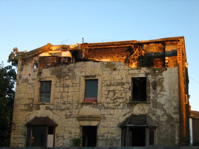 A stone house with a collapsed rooftop