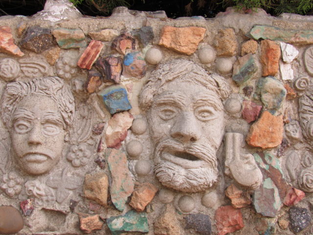 Stone heads surrounded by bright colored rocks