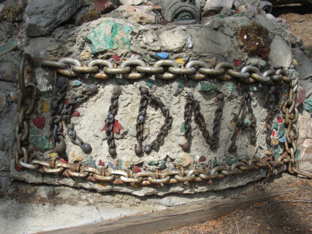 The word "kidnap" written in stone and surrounded by chains