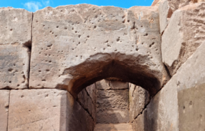 View of wall with musket ball holes and an archway.