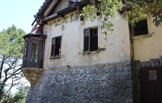 Exterior of the Mussolini Villa with trees on the periphery.