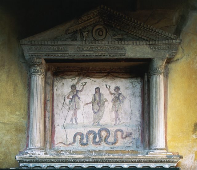 A Roman fresco surrounded by frame shaped like a house 