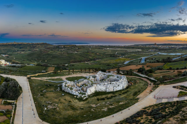 Aerial view of Ggantija Gozo with a sunset in the background.