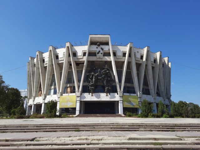 Exterior of the Chisinau State Circus, a tall circular building with beams along the sides.