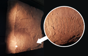 A full look at a sandstone slab with runes, with a close up of those runes on top
