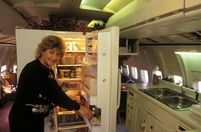 Jo Ann Ussery standing beside her open fridge in her plane home.