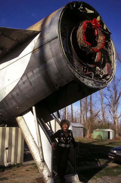 Jo Ann Ussery standing in front of the engine of her plane home.
