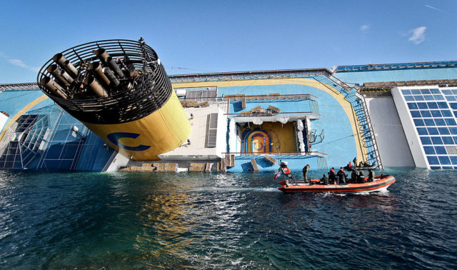 Costa Concordia on its side in the water.