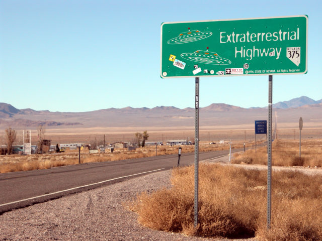 A highway sign in a desert, reading "Extraterrestrial Highway"