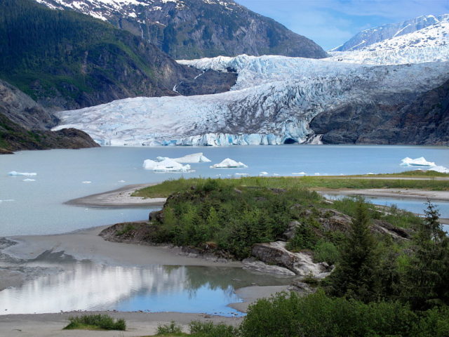 Distanced view of the Mendenhall Glacier as it meets the lake.