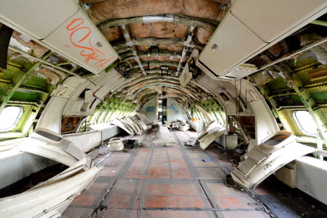 The interior of a plane, all insides removed and wall insulated visible. 