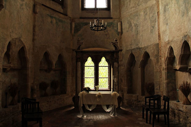 Interior of a gothic chapel with inlets carved into the stone. 