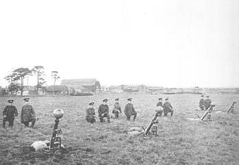 Group of soldiers in uniform near down in an open field.