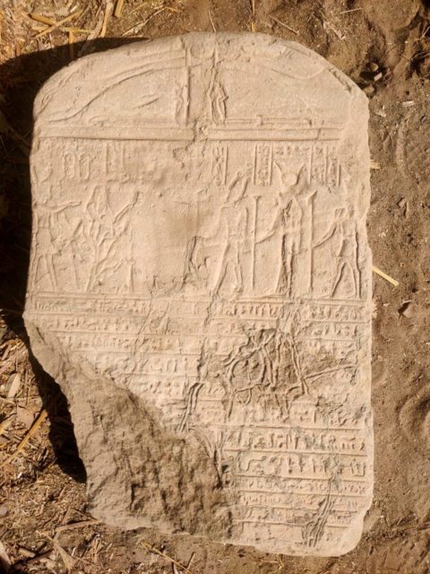 Ancient Egyptian tablet with hieroglyphics and demotic etched into it