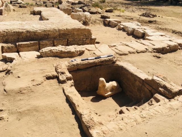 Sphinx statue in the middle of a stone pit