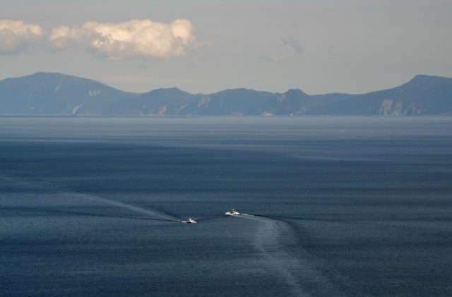Two boats sailing near Kunashir Island