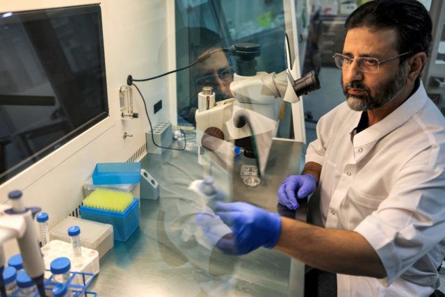 Nasir Ahmad Wani examining samples at a desk