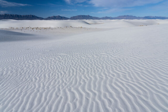 View across pale sand at White Sands National Park in New Mexico. 