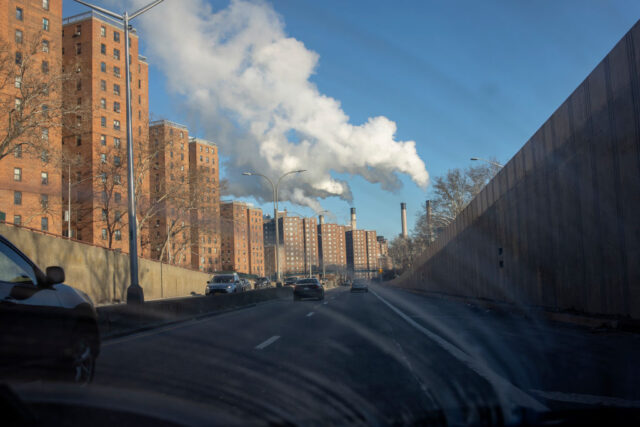 Steam riding from a plant in New York viewed from inside a car. 