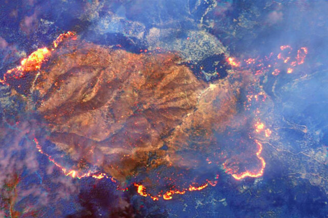 A satellite view of wildfires spreading across California.