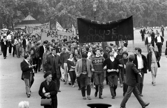 Group of protestors marching with signs outside Porton Down.