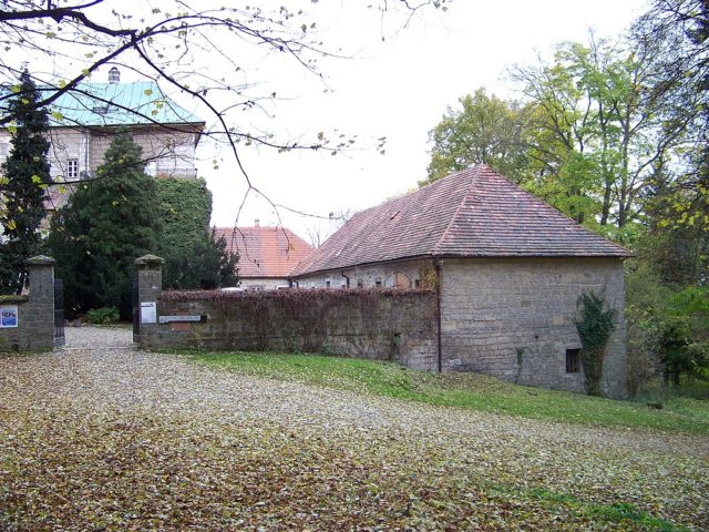 Gate with buildings around it. 