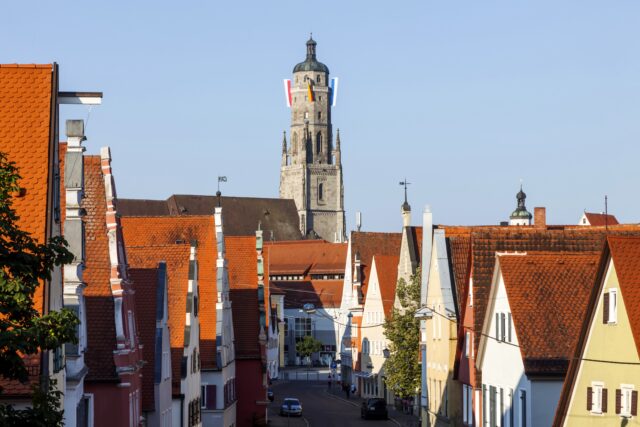 A photo of a street in Nordlingen lined with buildings. At the end of the street is the tower of St. George's Church, known as "Daniel."