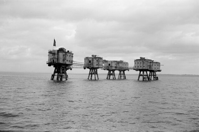 Numerous metal platform forts in the water.