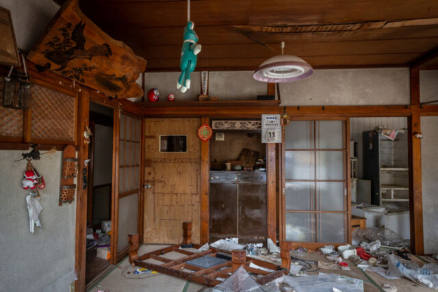 Debris and personal belongings strewn around a large room