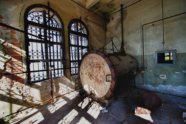 Rusty machinery in a room with large windows