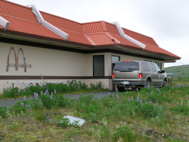 Car moving through the drive-thru of the abandoned McDonald's near the Adak Army Base and Naval Air Facility