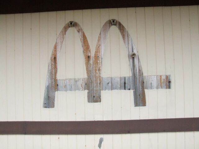 Shadow of the McDonald's logo on a white exterior wall