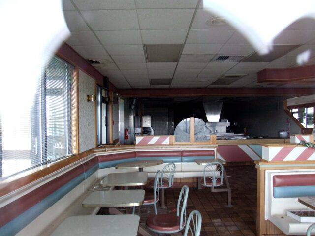 Interior of a McDonald's restaurant, as seen through a broken window