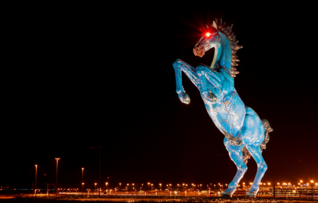 The "Mustang" sculpture at night.
