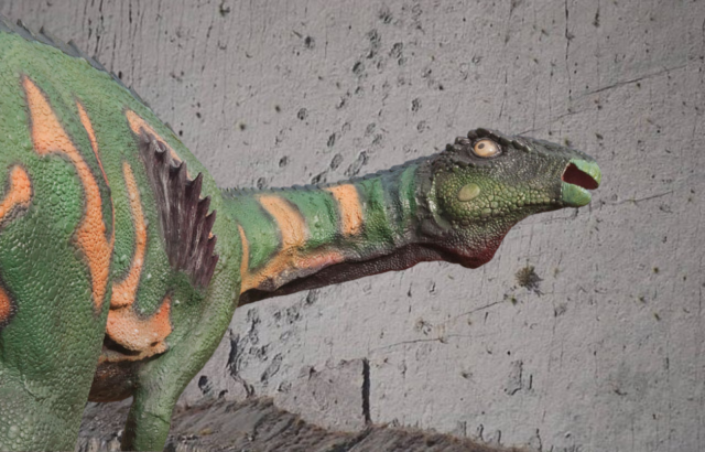 Close-up of the dinosaur tracks on Cal Orck'o + Life-size fiberglass statue of a dinosaur
