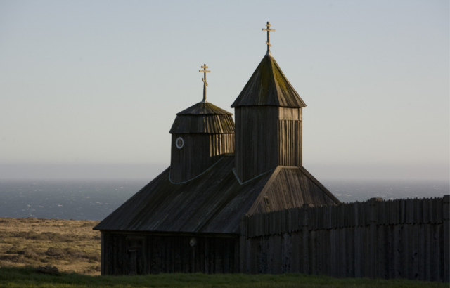 The sun begins to set on the chapel at Fort Ross