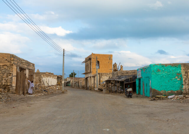 A run-down street with decaying buildings.